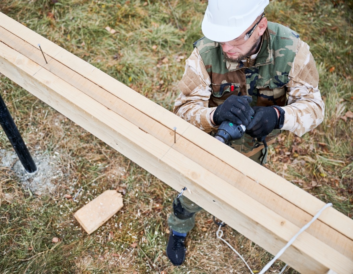 Cedar fence post replacement on an existing steel pipe fence post