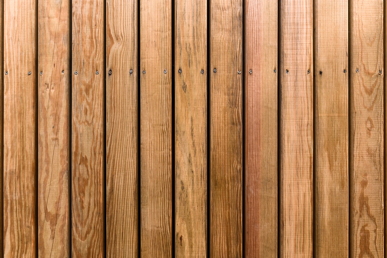 Faux wood vinyl fence with embossed woodgrain texture