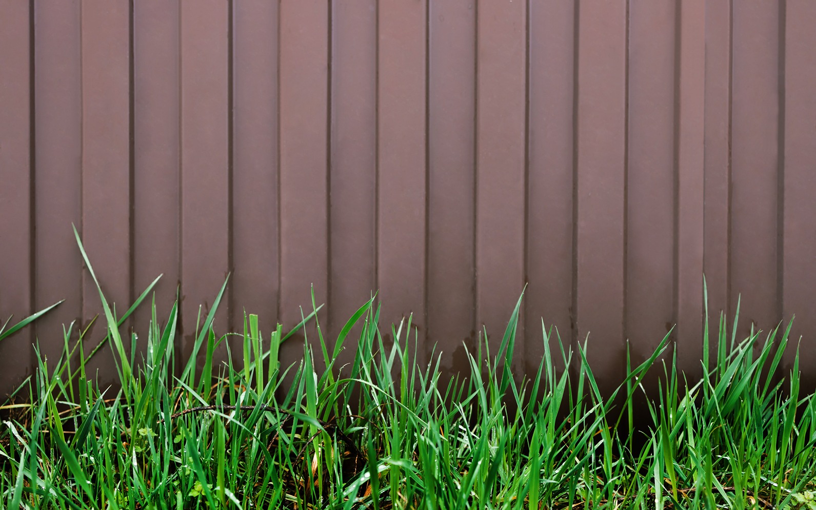 wood grain vinyl privacy fence in dark brown color