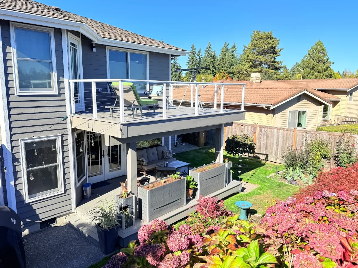 A finished two-level deck project in Tacoma facing a garden