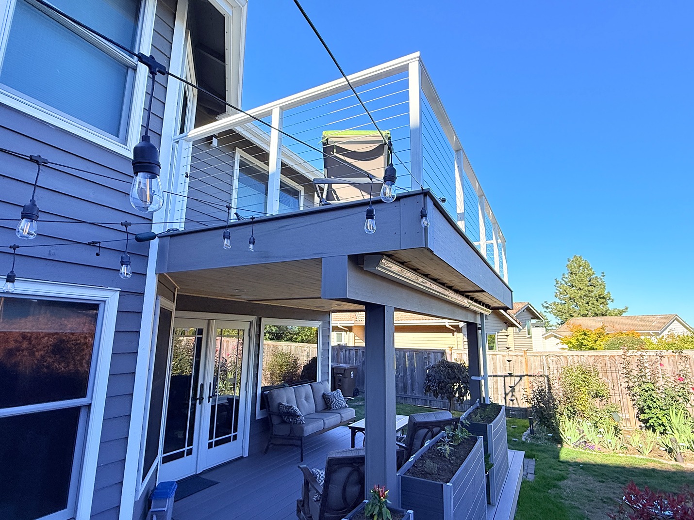 A close-up look at the finished two-level deck project in Tacoma with seating area