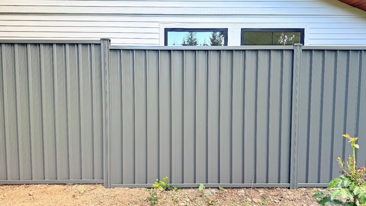 Gray ColorMax fence installed in a Bellevue home for increased privacy