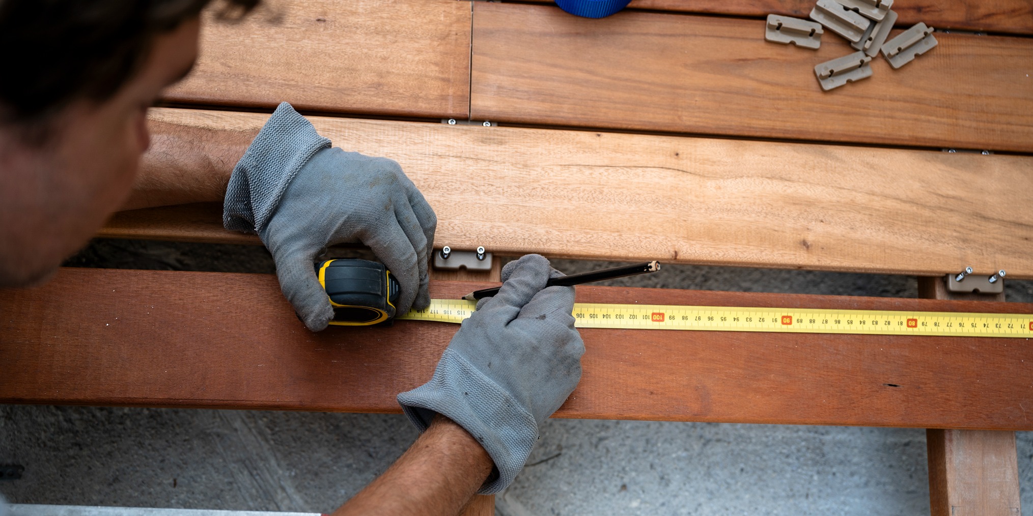 Professional fence installation with post spacing measurement for a WPC composite fence in Bellevue