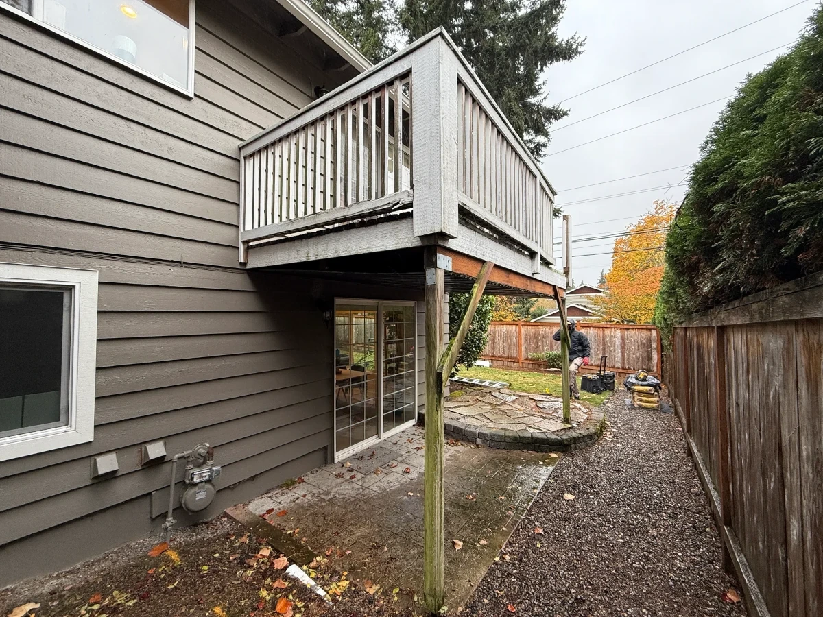 Deteriorating deck with faded wood and unstable railing posts