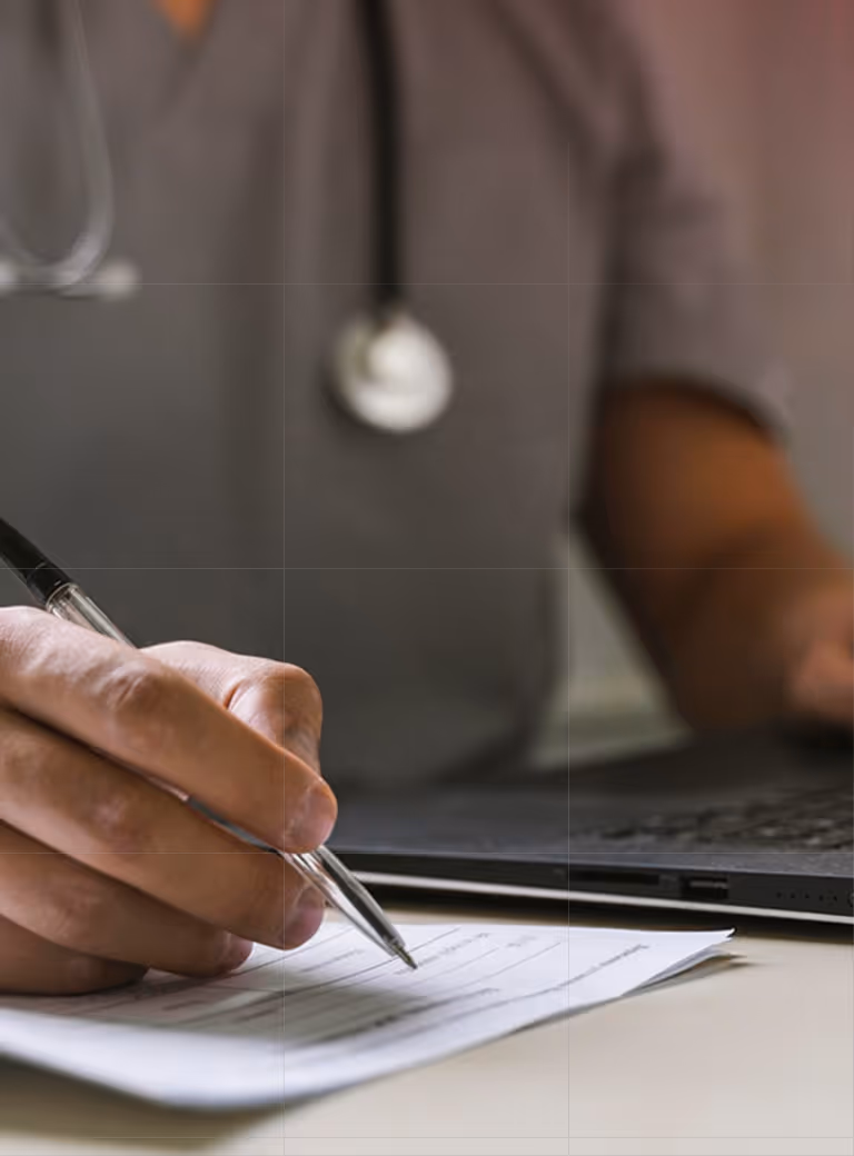 A man in scrubs filling out a form