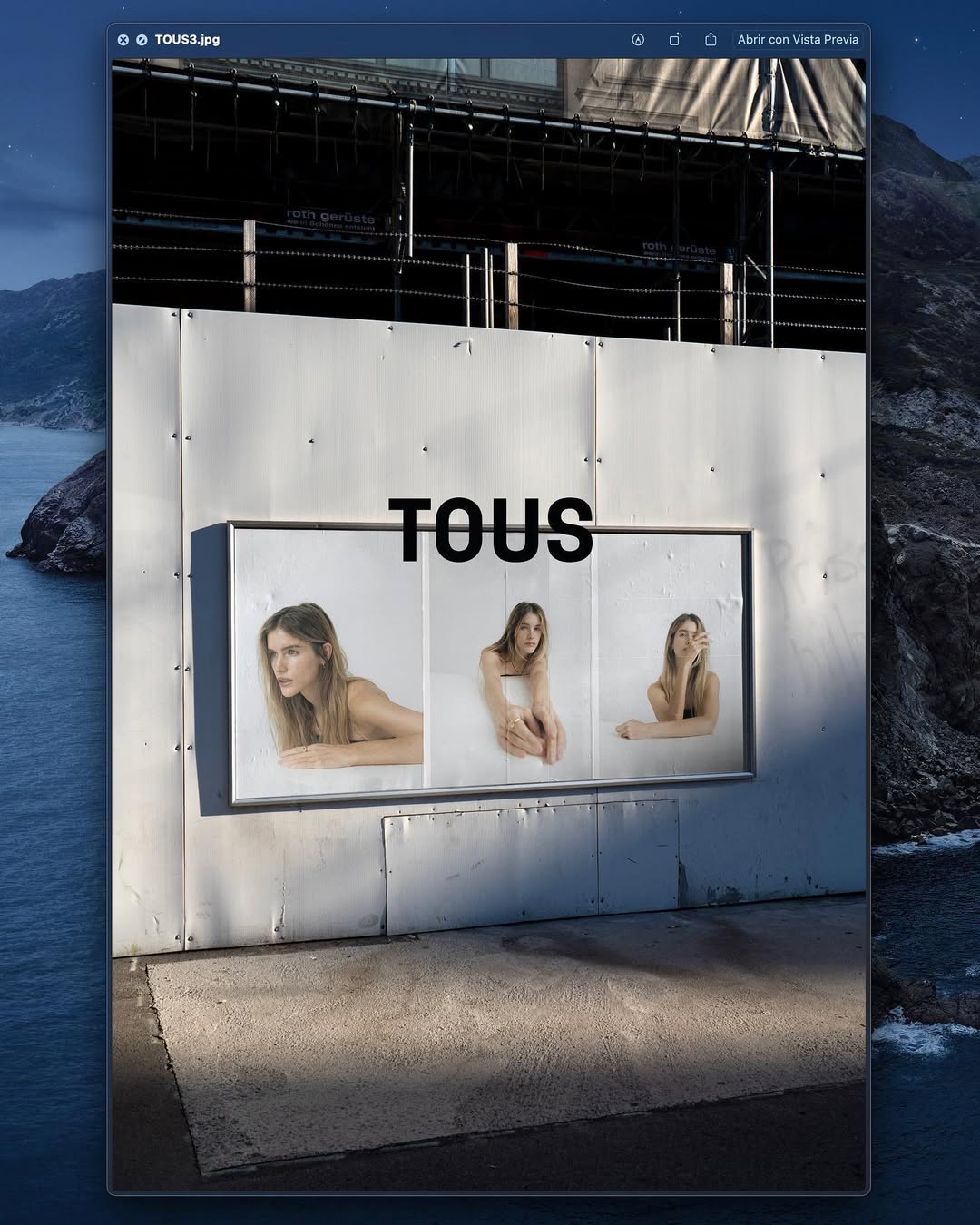 Older man wearing dark sunglasses and a navy sweater sitting at a table, holding a white gift box with a red ribbon, with text saying 'Sunnies that say "I know what I like"'.