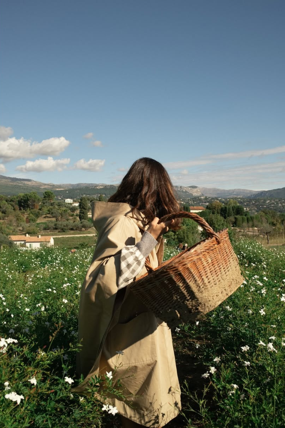 Older man wearing dark sunglasses and a navy sweater sitting at a table, holding a white gift box with a red ribbon, with text saying 'Sunnies that say "I know what I like"'.