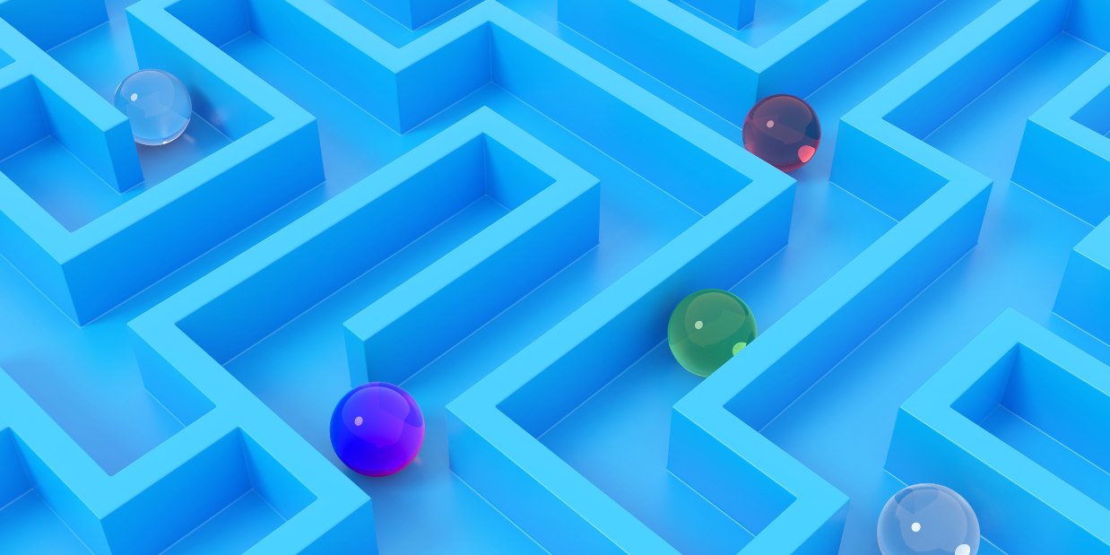 Marbles going through a blue maze.