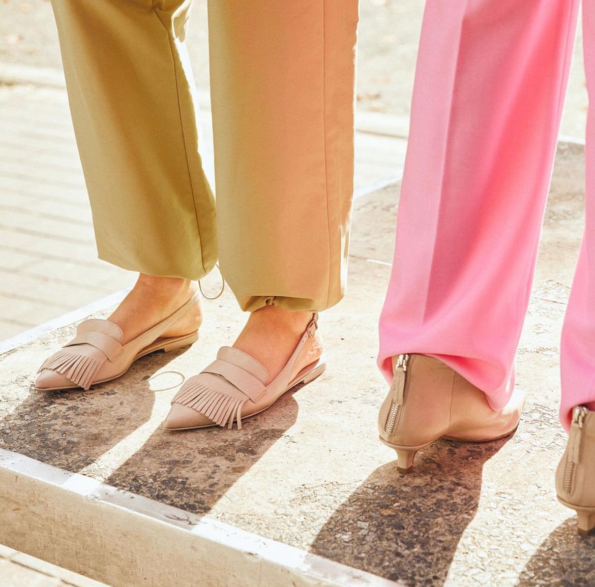 Closeup shot of women wearing trousers and beige formal shoes.