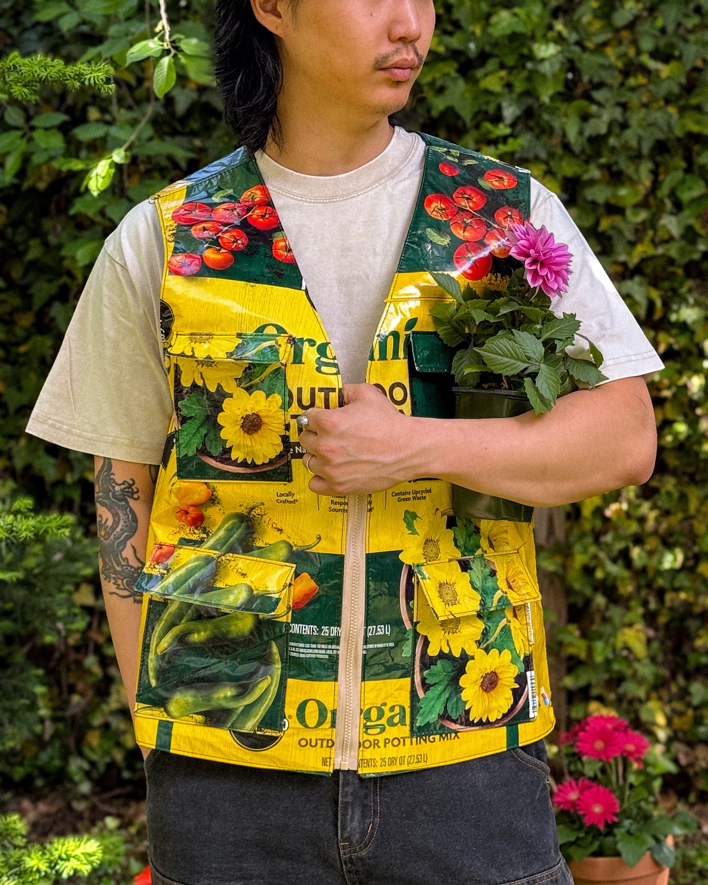 Close view of the Miracle-Gro soil-bag vest showing its pockets, front zipper, and Haberdash label