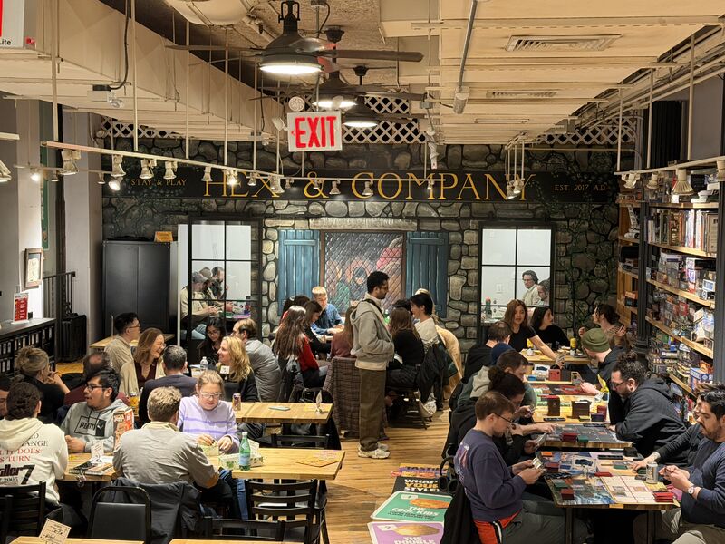 Guests playing tabletop games during the TAST!EZ Game Night event at Hex & Co in New York City