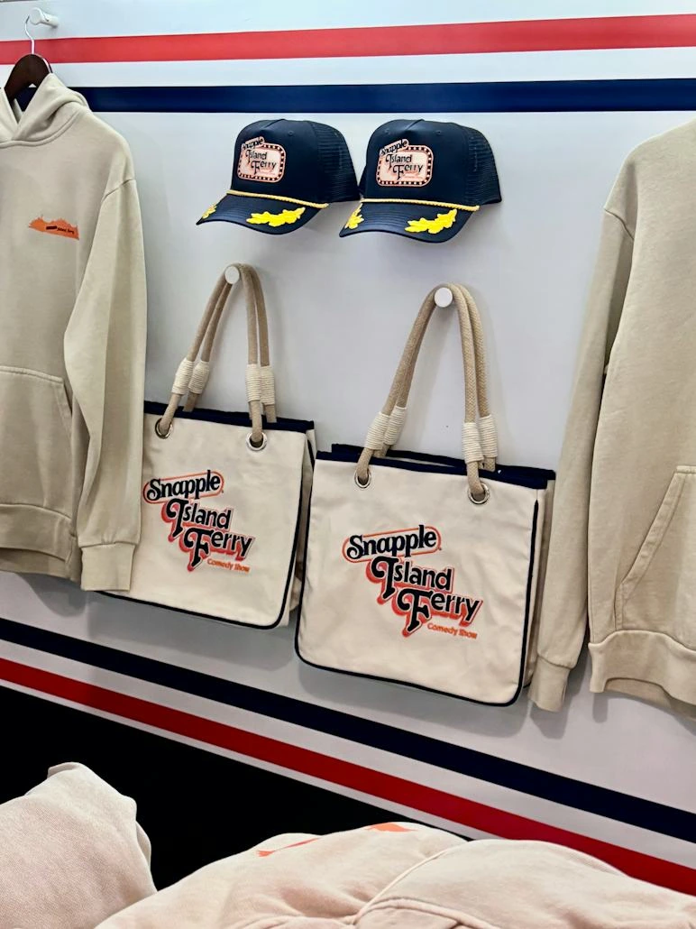 Actual event merchandise booth displaying the appliqué totes, captain caps and hoodies