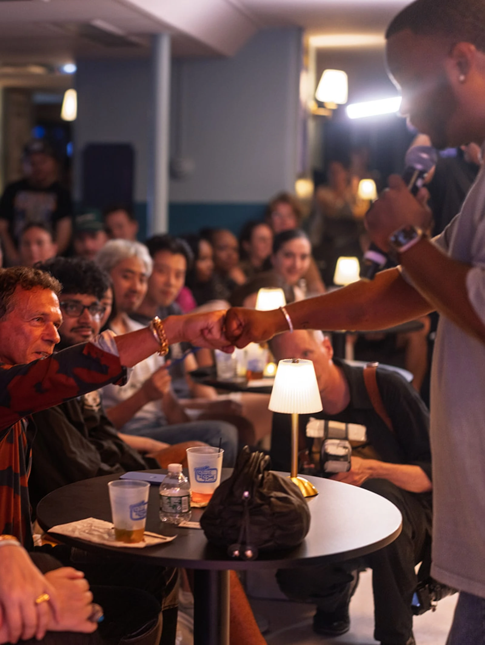 A comedian interacting with an audience member aboard the ferry