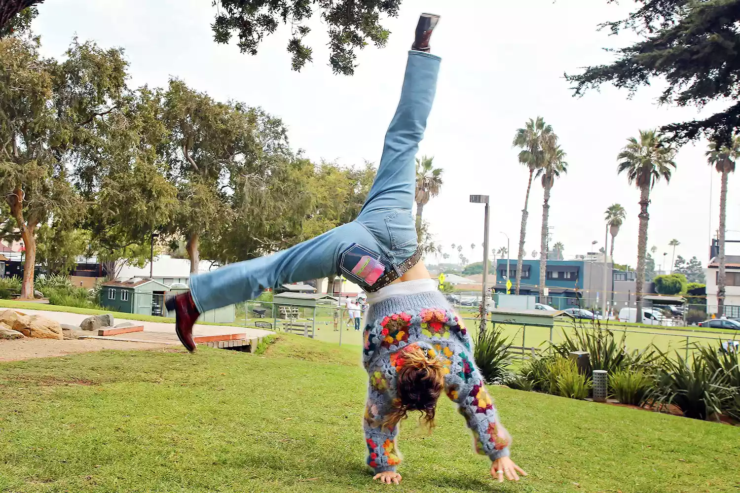 Haley Lu Richardson doing a cartwheel in the clear-pocket MaxiMalism jeans