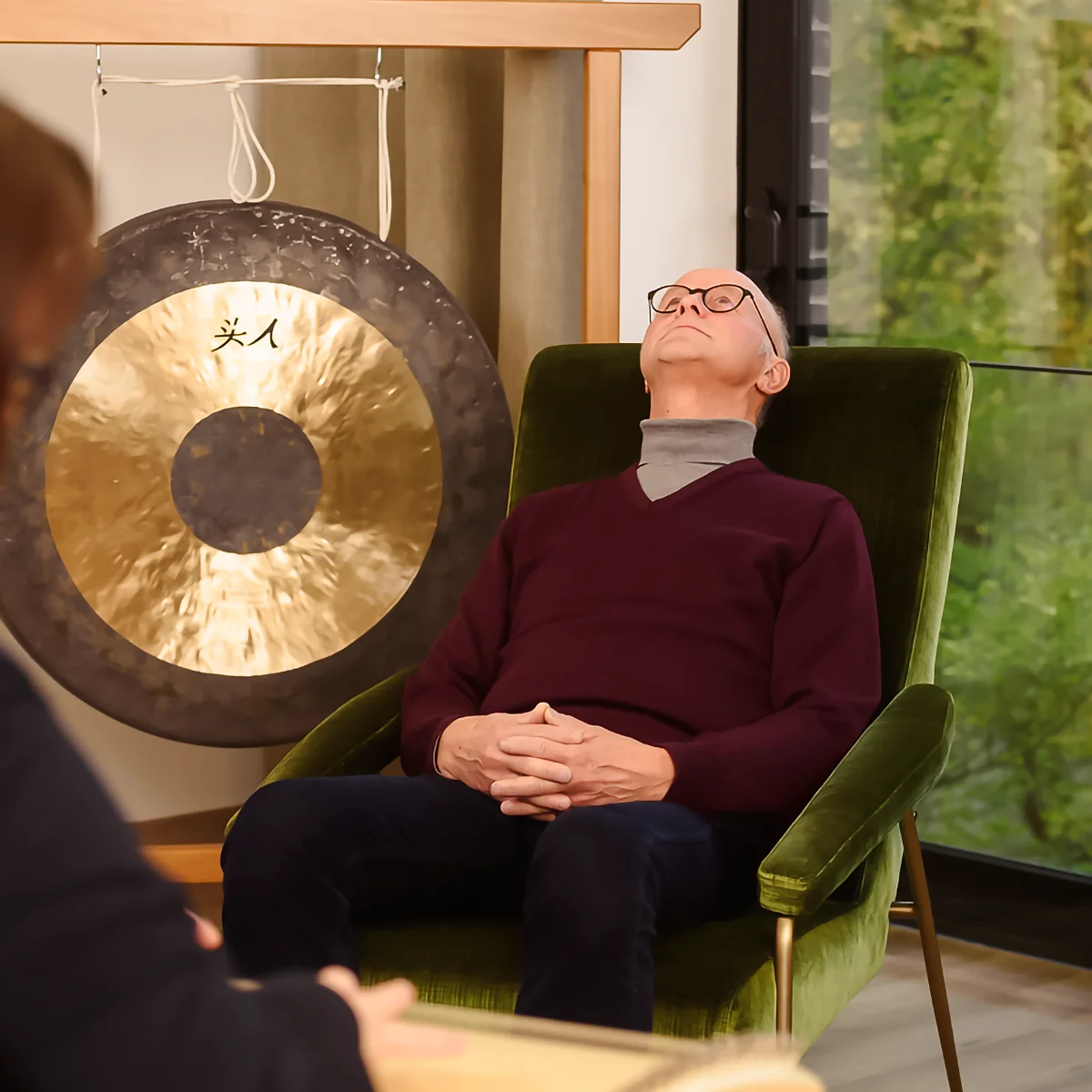 Ein Mann bei der Hypnose. Er sitzt zurückgelehnt in einem Sessel.