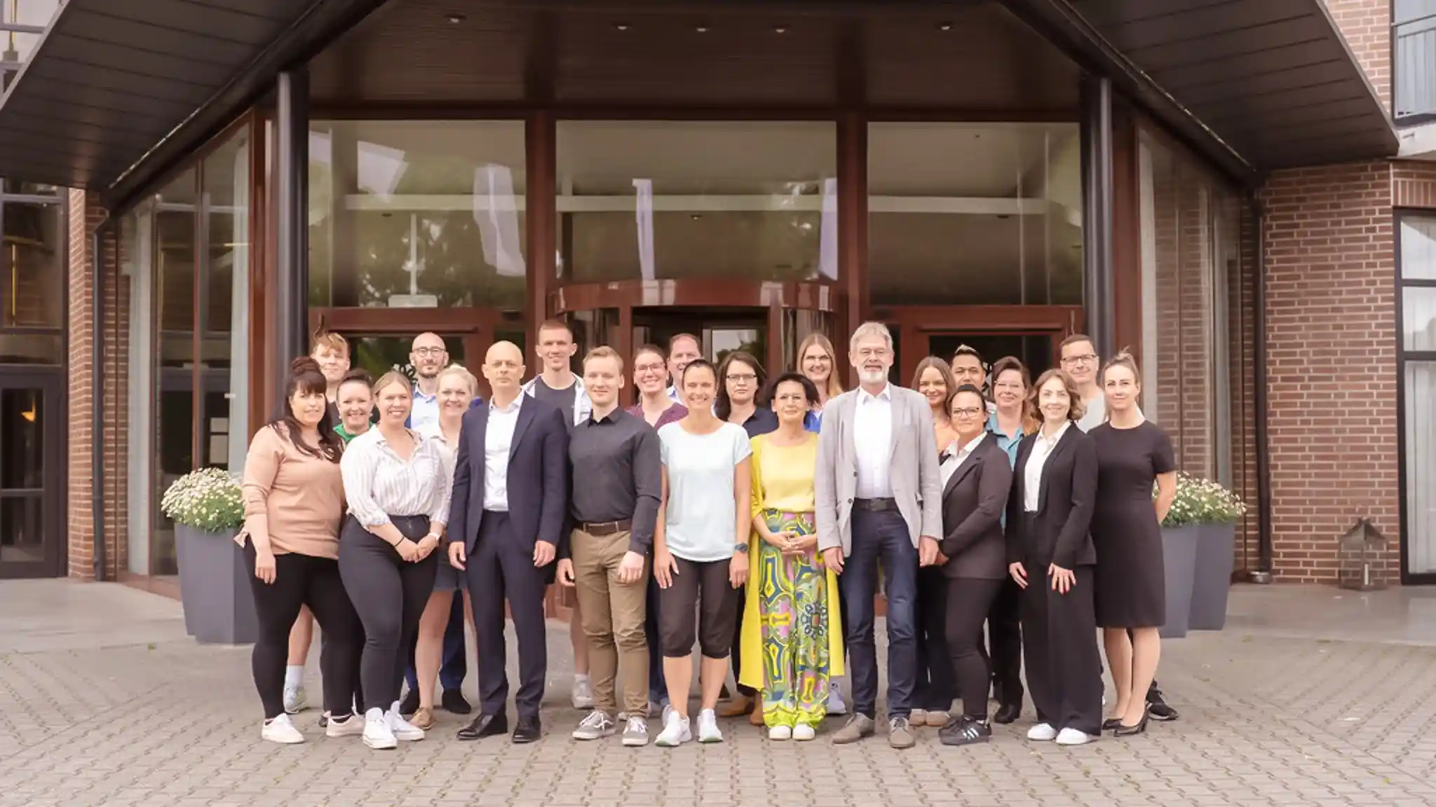Das Team der Vincera Kliniken steht in einem Gruppenbild vor dem Eingang der Klinik