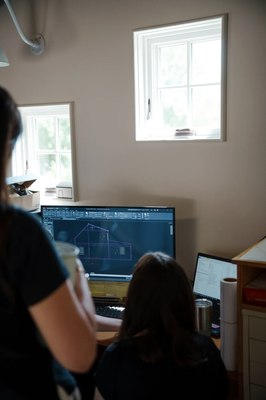 BNA team collaborating in front of computer