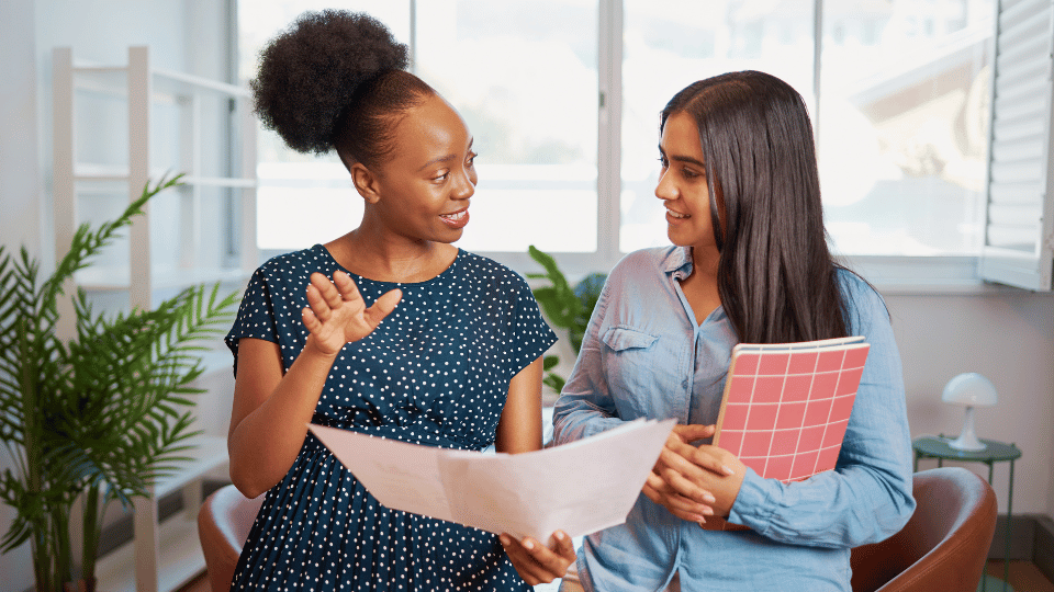 Two women engaged in a discussion in an office setting, emphasizing a streamlined treatment process