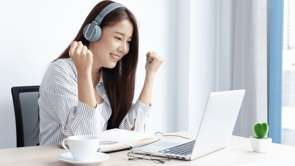 A woman wearing headphones works on a laptop at her desk, highlighting affordable membership options for CEUs.