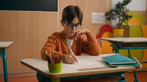 Kid writing on a paper