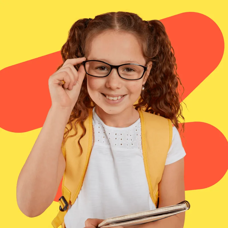 A young girl wearing glasses holding a tablet.