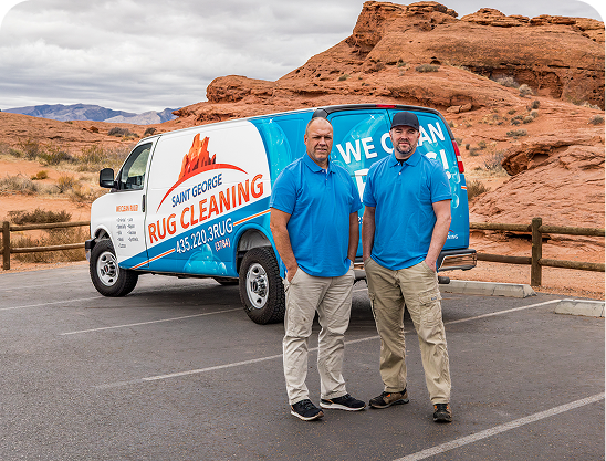 Two men standing with arms crossed in front of a Salt Lake City Rug Cleaning van parked outside.