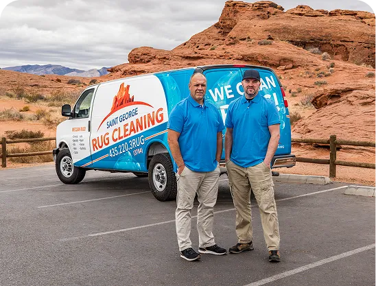 Two men standing with arms crossed in front of a Salt Lake City Rug Cleaning van parked outside.