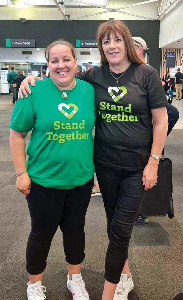 Two PSA members wearing Stand Together campaign t-shirts.
