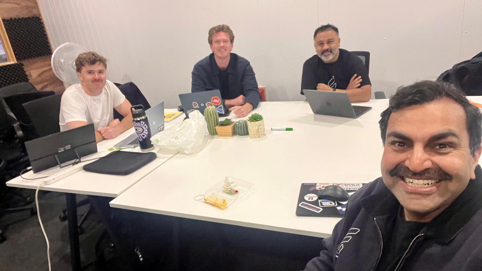 Deep Space team working together around a desk in the office