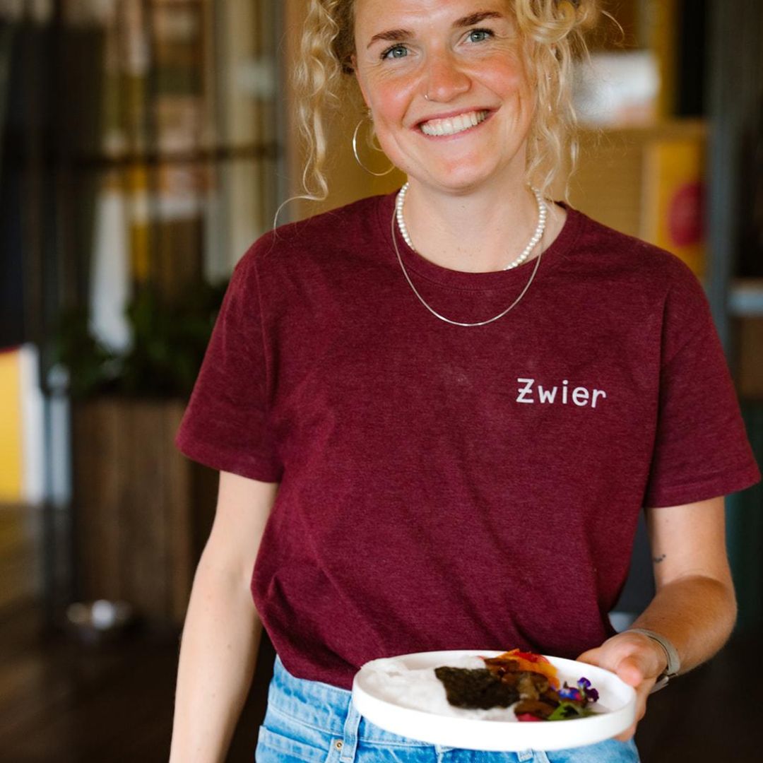 Vrouw in een Zwier-shirt met een bord eten