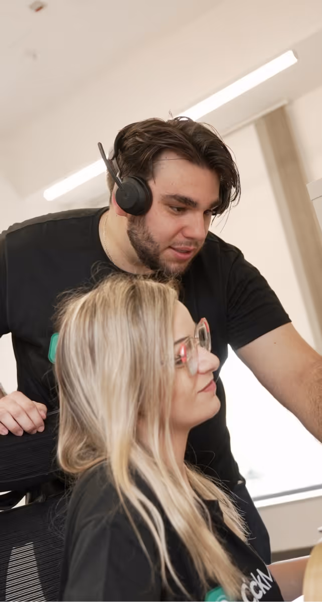 Colleagues talking on a headset with a client
