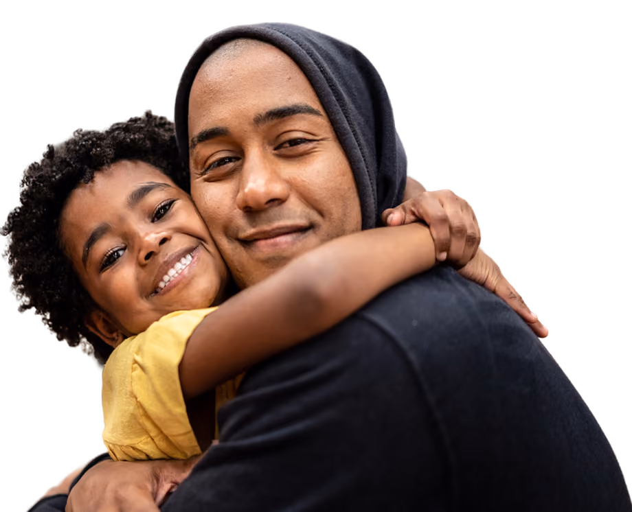 Portrait of father and daughter embracing at a community center