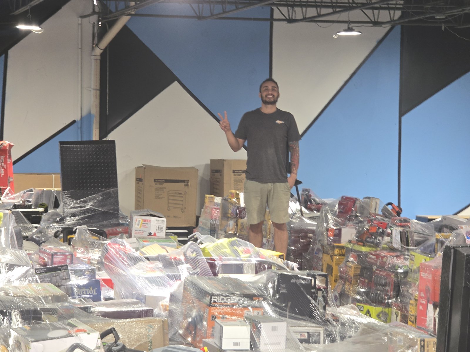 Liquidation SA owner in the San Antonio warehouse full of tool pallets