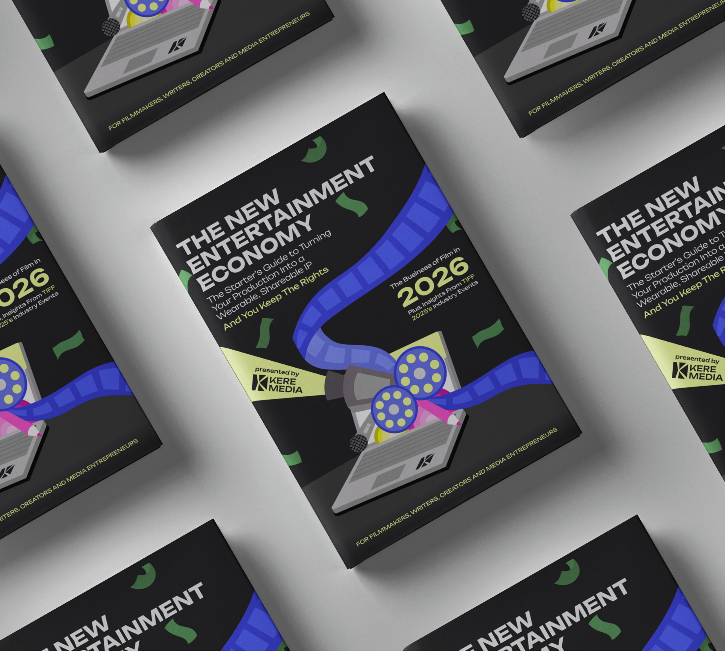 Flat lay of multiple copies of a book titled 'The New Entertainment Economy' featuring film reels coming out of a laptop illustration.