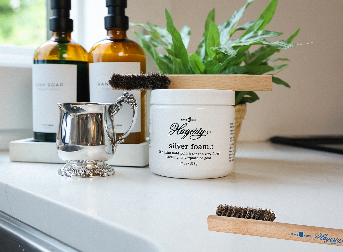 A bottle of Hagerty Silver Foam on a counter with Hagerty Brush and beautiful silver
