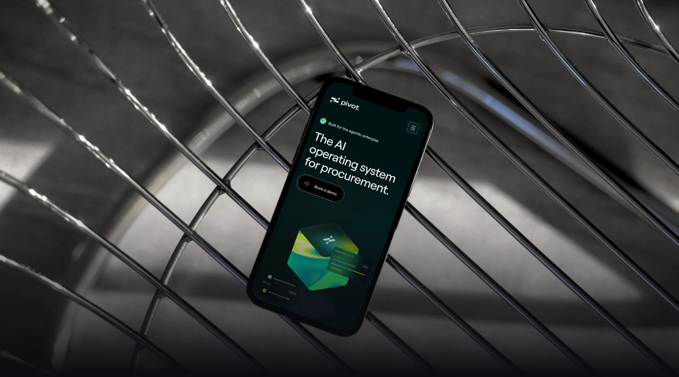 Pivot website on a phone, held among curved steel rails