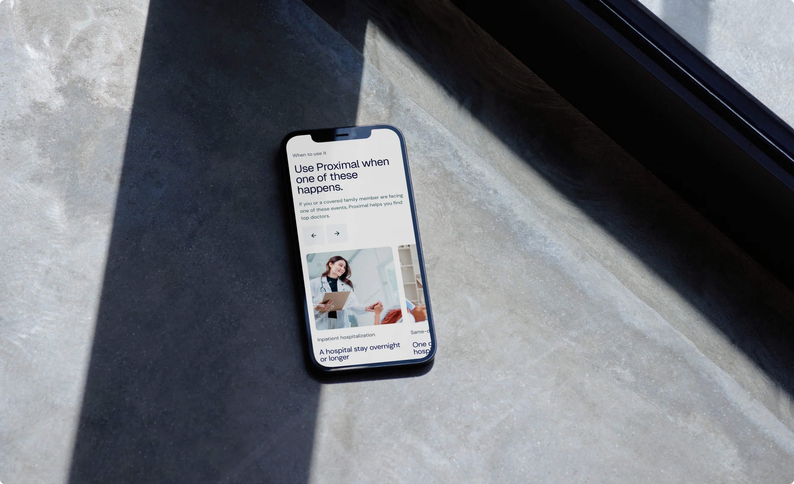 Proximal website on a phone resting on a stone table