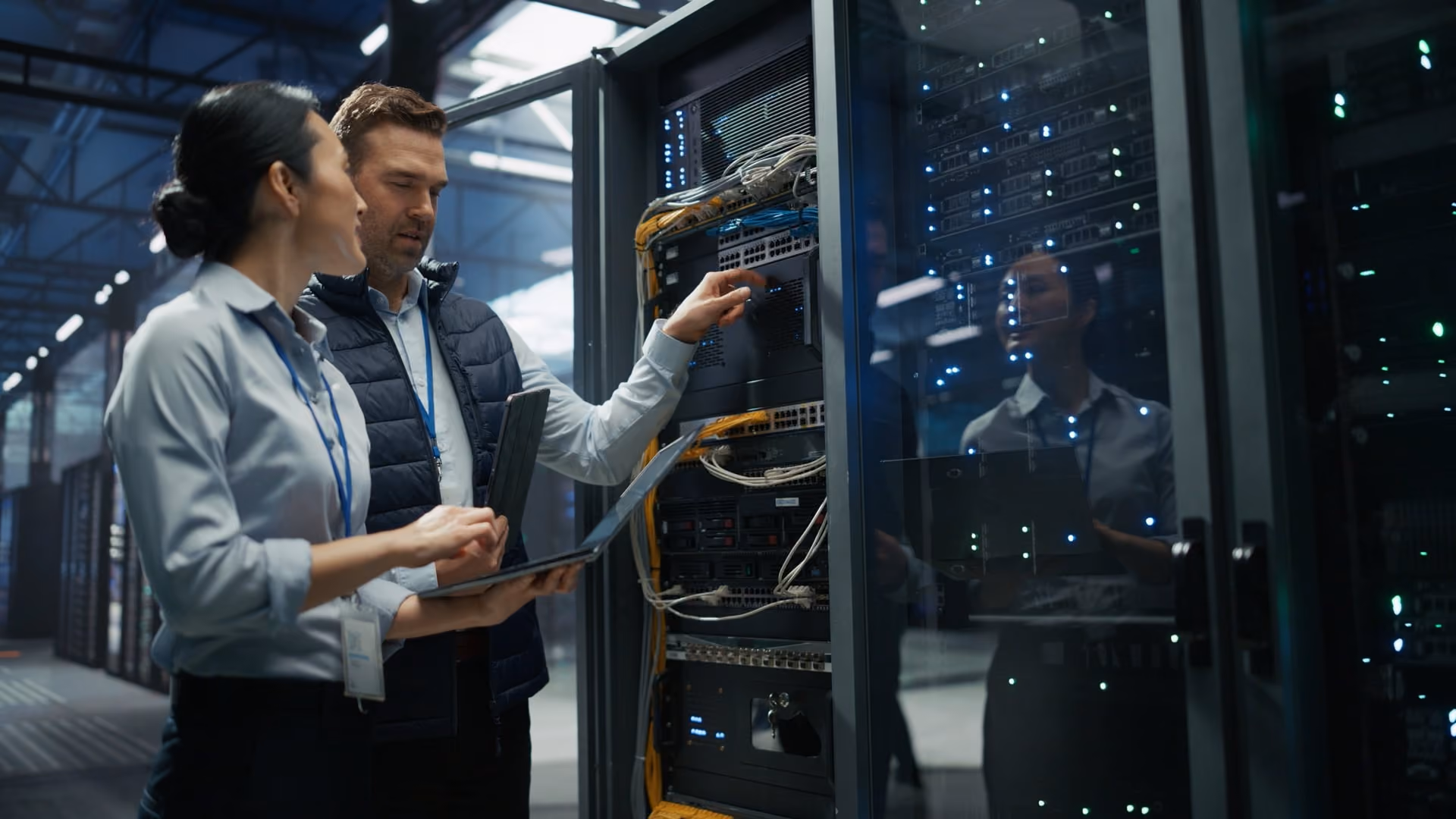 Server rack team reviewing laptop