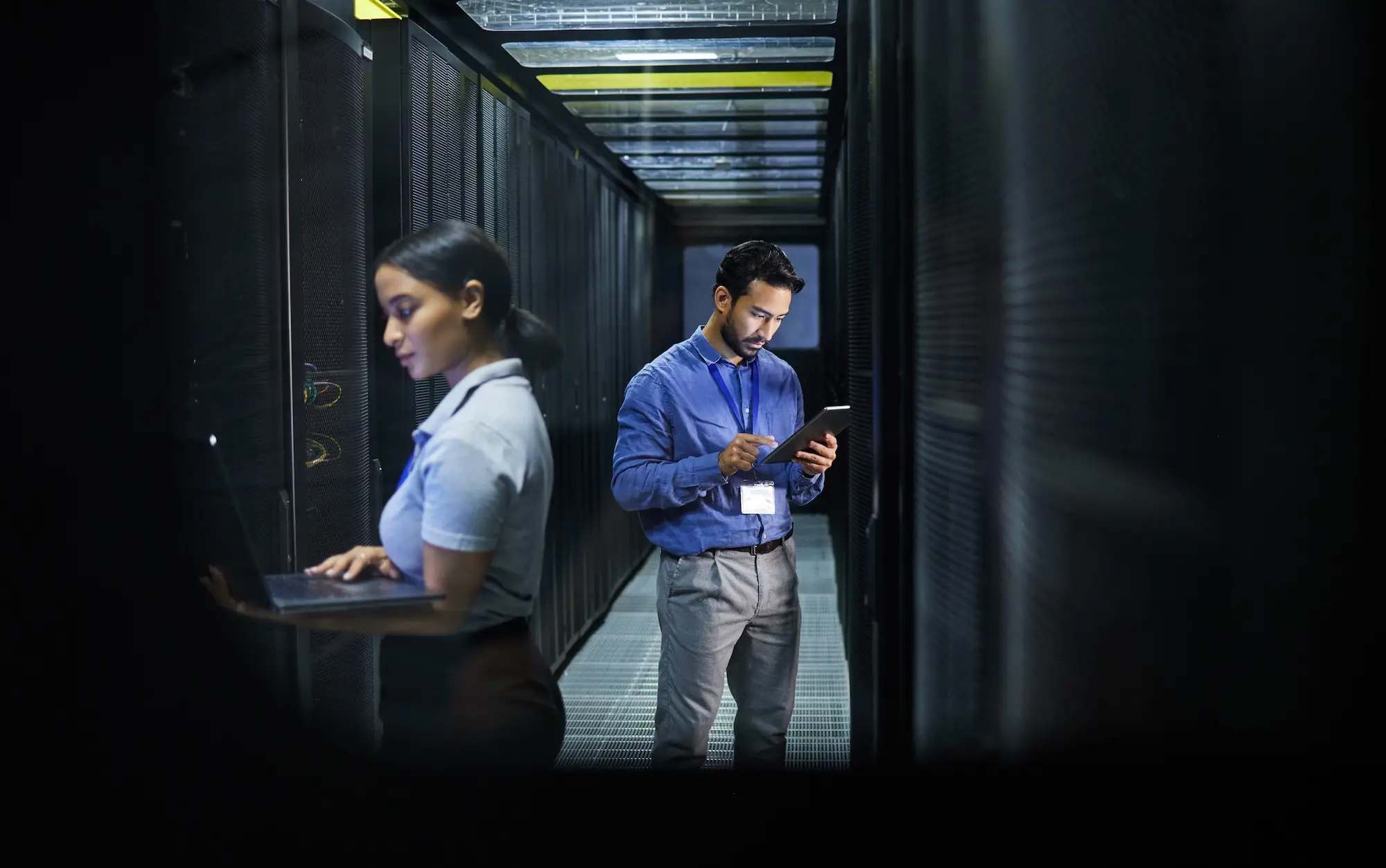 IT professionals monitoring servers and infrastructure inside a secure data center