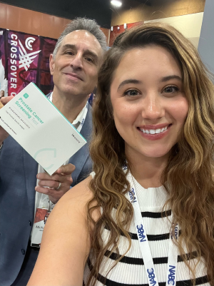 Two people smiling and holding up an imaware Prostate Cancer Screening Test kit