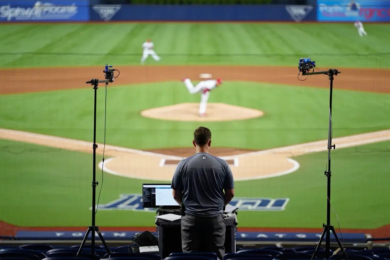 A coach assessing a baseball game live