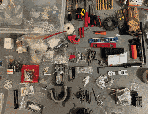 Tools and hardware sorted into micro categories on a workbench