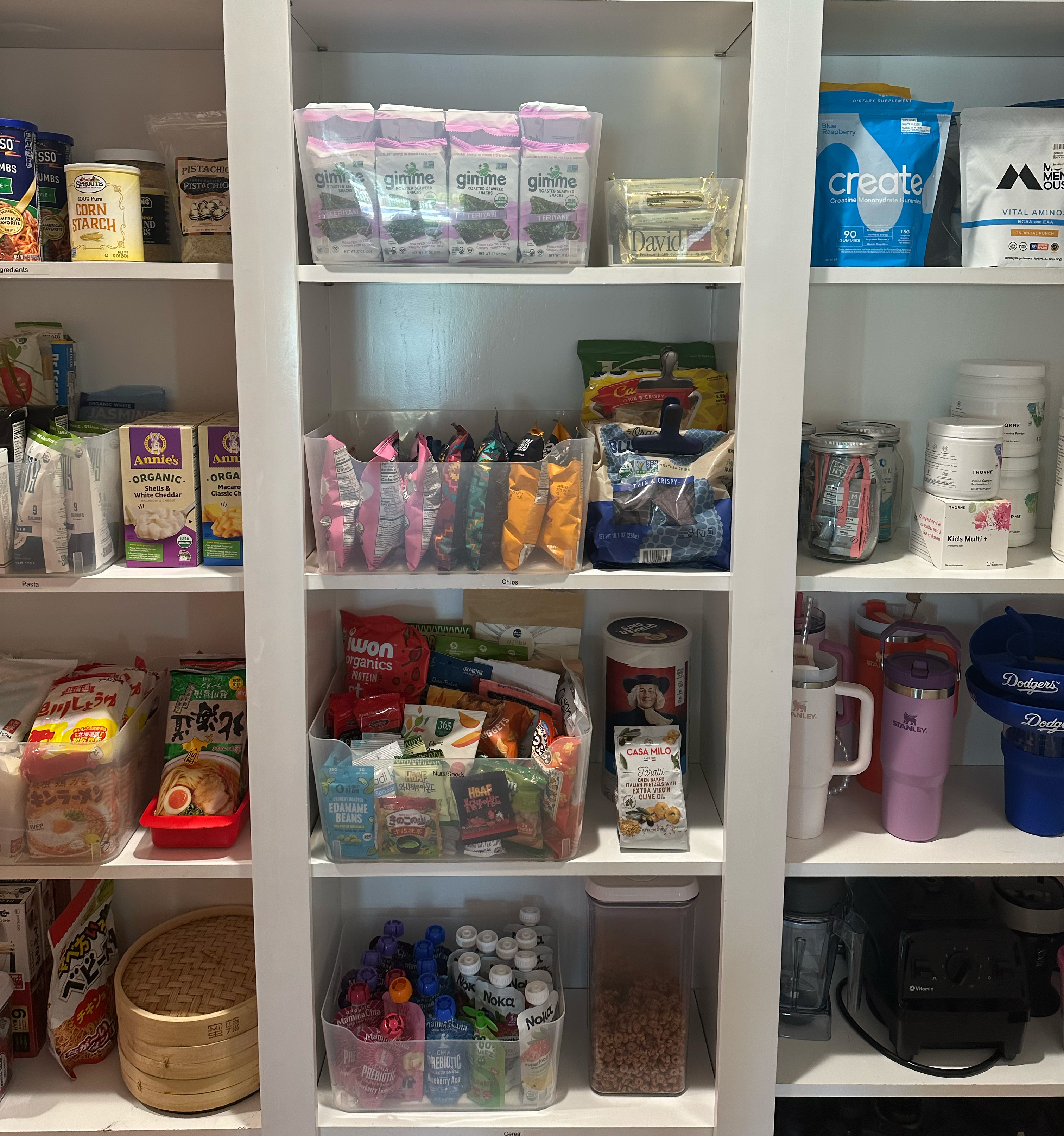 Organized pantry with clear bins and labeled zones