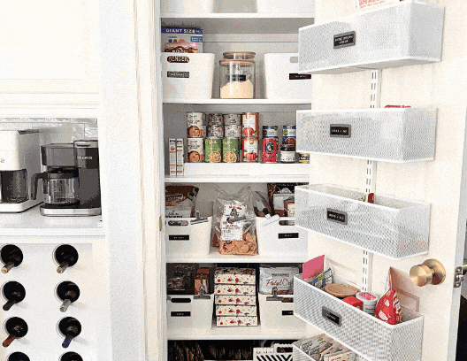 Organized pantry with categorized bins on light wood shelves