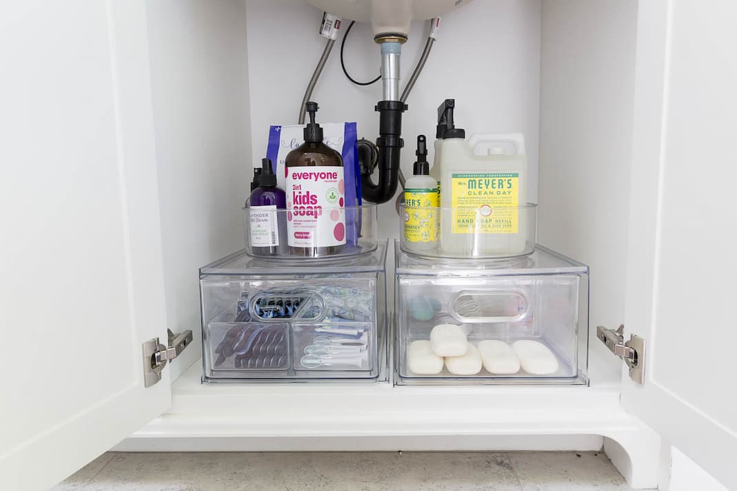 An organized bathroom drawer with fitted dividers separating everyday items