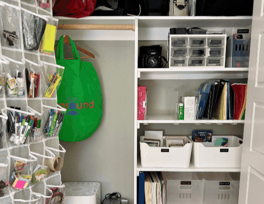 An over-the-door shoe organizer holding small household items sorted into its pockets