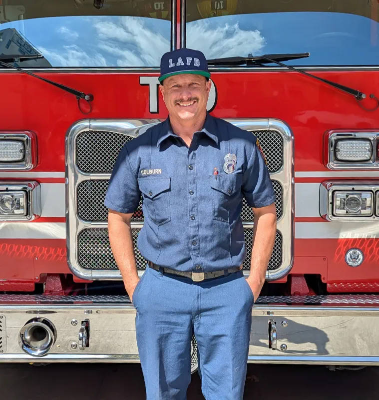 Engineer Brandon Colburn standing in front of an LAFD engine.
