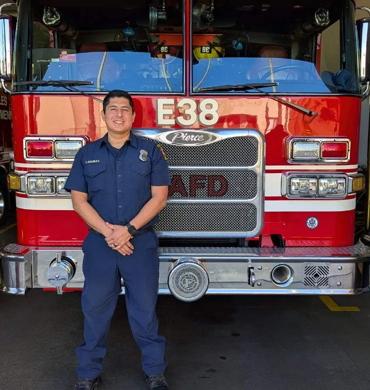 Engineer Brandon Colburn standing in front of an LAFD engine.