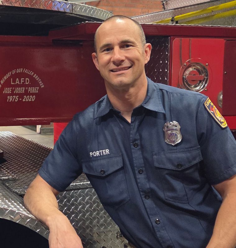 Engineer Brandon Colburn standing in front of an LAFD engine.