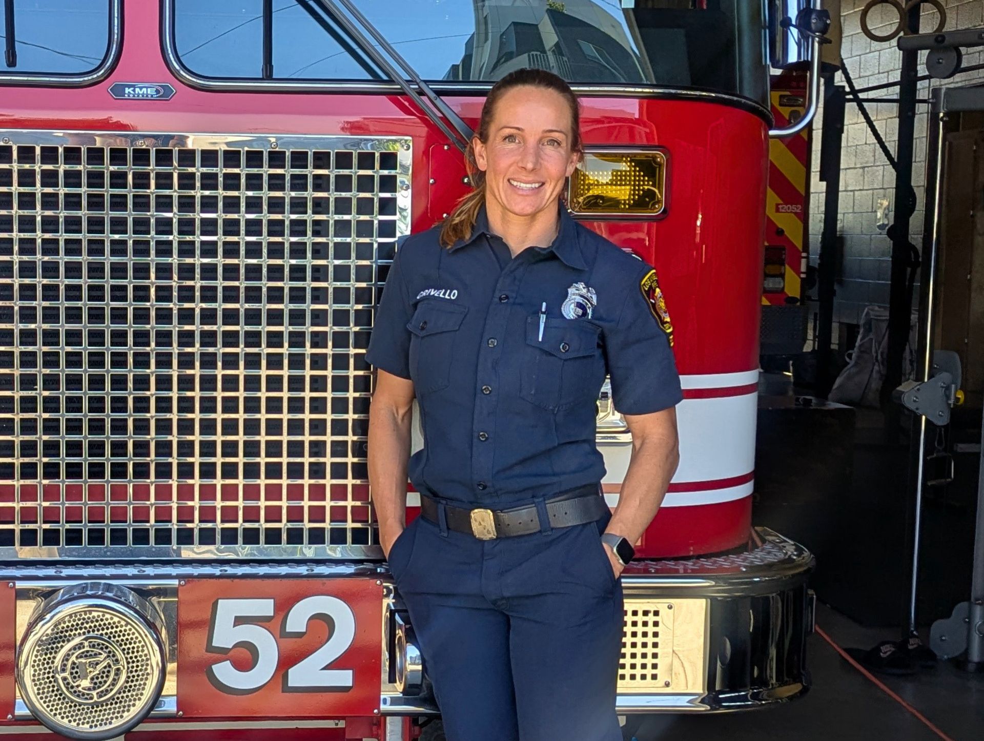 Engineer Brandon Colburn standing in front of an LAFD engine.